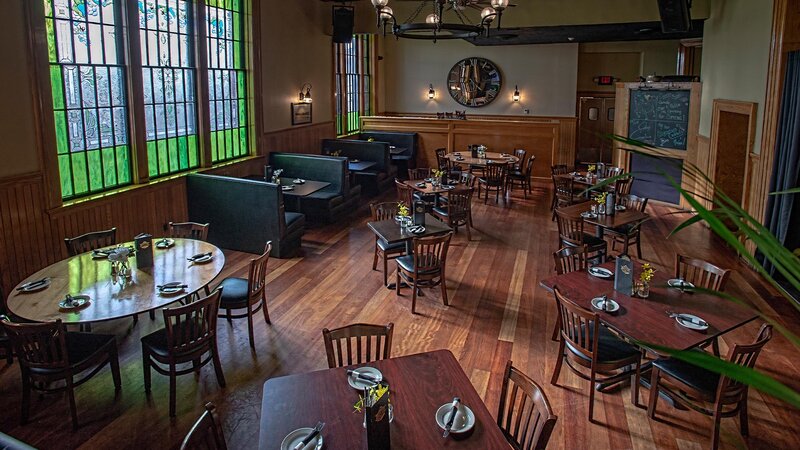 Dining room with booth seating and round and square tables