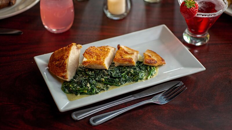 Fried fish entree with spinach